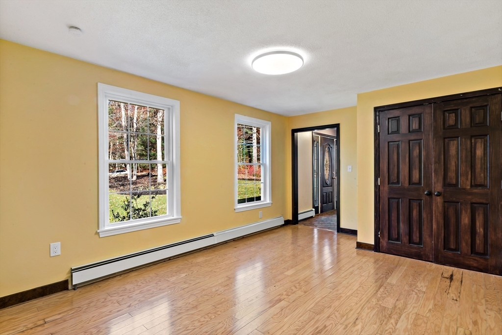 15 Hickory Ridge Road Rehoboth, MA 02769 - Photo 17 of 42 a view of an empty room with glass door and wooden floor