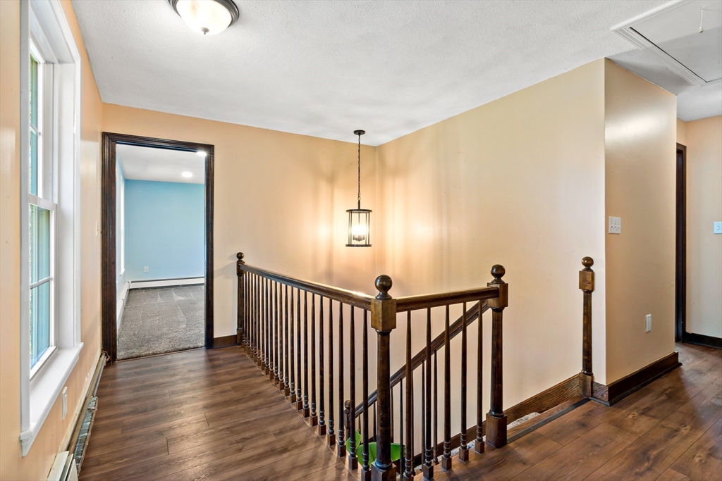 15 Hickory Ridge Road Rehoboth, MA 02769 - Photo 19 of 42 a view of a hallway with wooden floor and stairs
