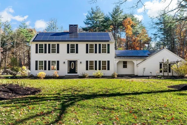 a front view of a house with a garden and yard