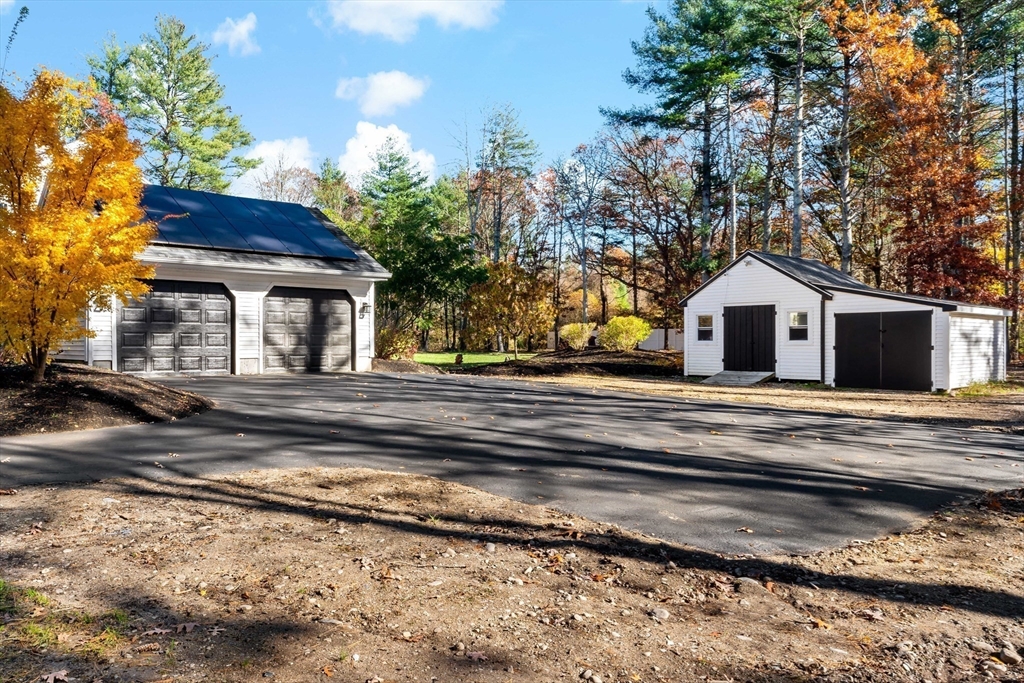 15 Hickory Ridge Road Rehoboth, MA 02769 - Photo 31 of 42 a white house with a large tree next to a yard