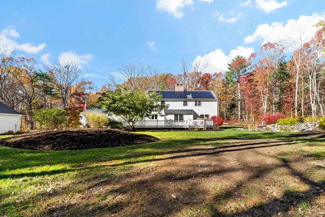 a view of a house with a yard and sitting area