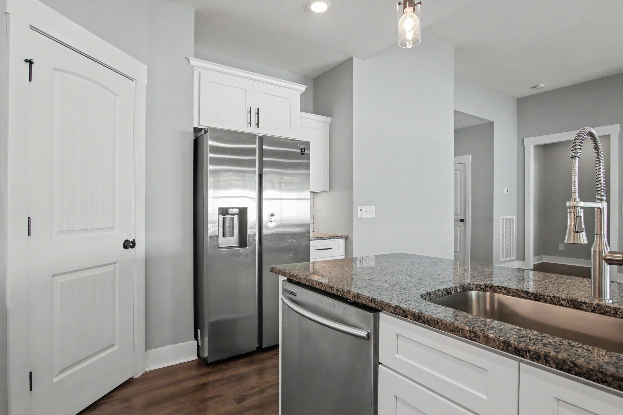 7208 Winding Way Pleasant View, TN 37146 - Photo 14 of 30 a kitchen with granite countertop a refrigerator and wooden floor