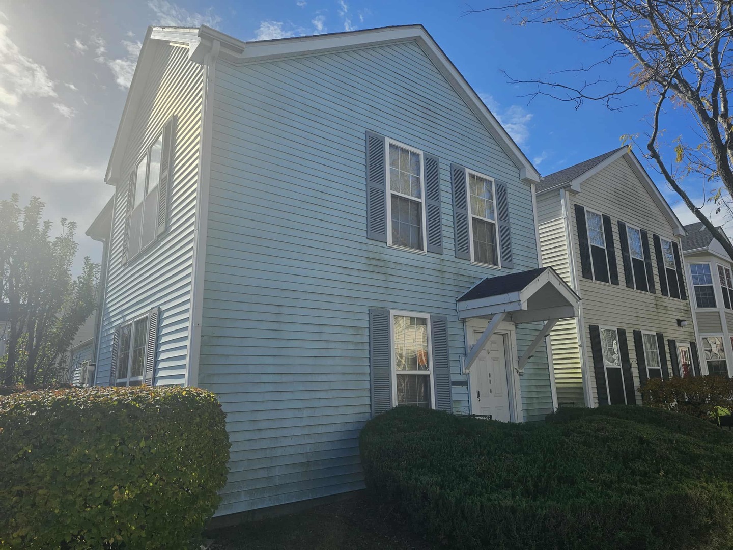 863 Symphony Drive, Unit 863 Aurora, IL 60504 - Photo 1 of 1 a front view of a house with a garden