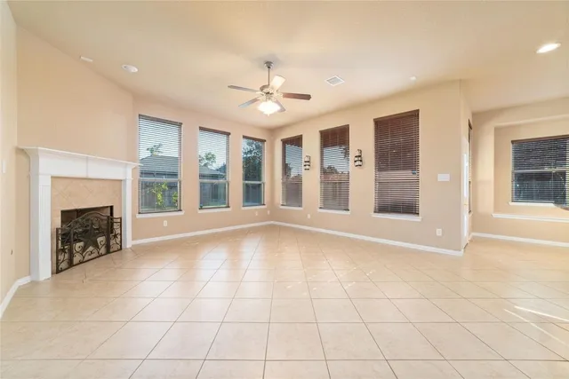 a view of an empty room with a fireplace and a window