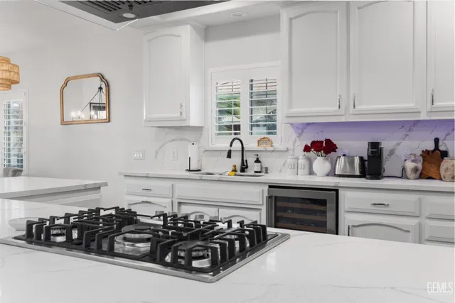 a kitchen with white cabinets and a stove