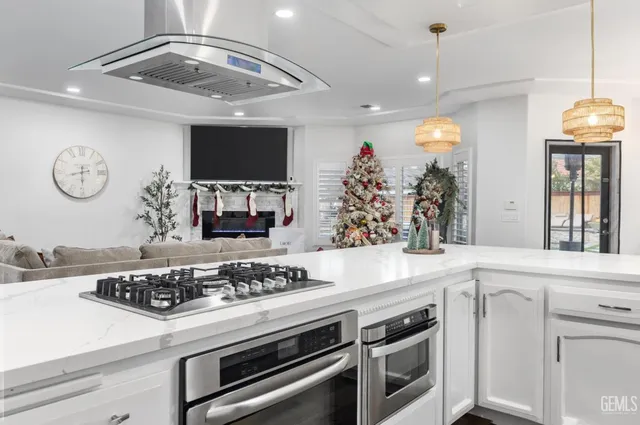 a kitchen with a stove and a white cabinets