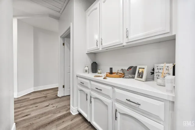 a kitchen with cabinets and a wooden floor