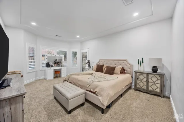 a spacious bedroom with a bed and a couch