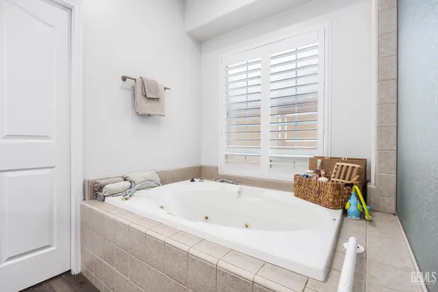 a bathroom with a tub and a window
