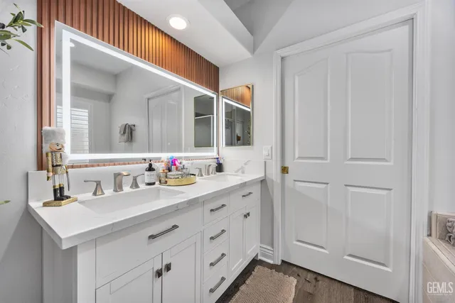 a bathroom with a double vanity sink and a mirror
