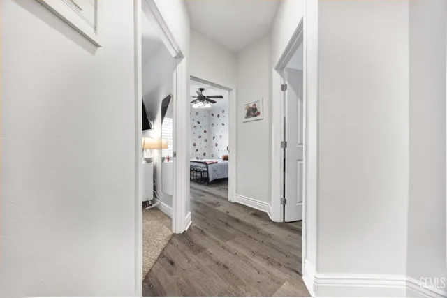 a view of a hallway with wooden floor