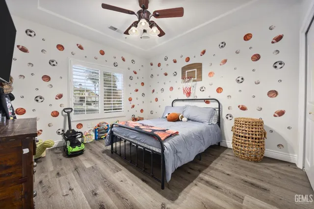 a bedroom with a bed and a chandelier