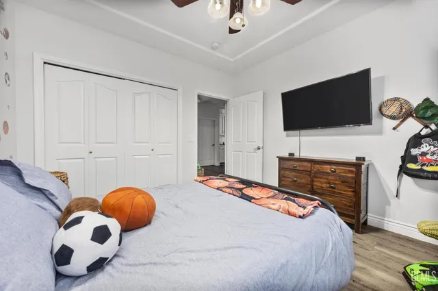 a bedroom with a bed and a flat screen tv