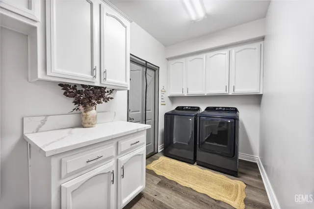 a kitchen with white cabinets and sink