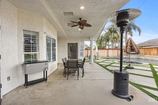 a dining room with furniture and a floor to ceiling window