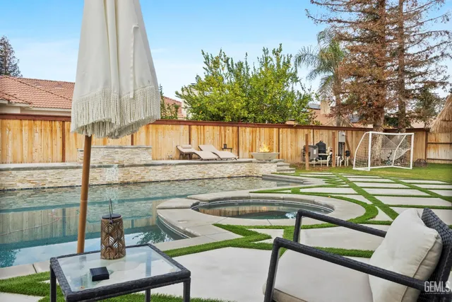 a view of swimming pool with outdoor seating and city view