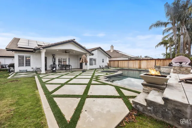 a view of a house with pool and chairs