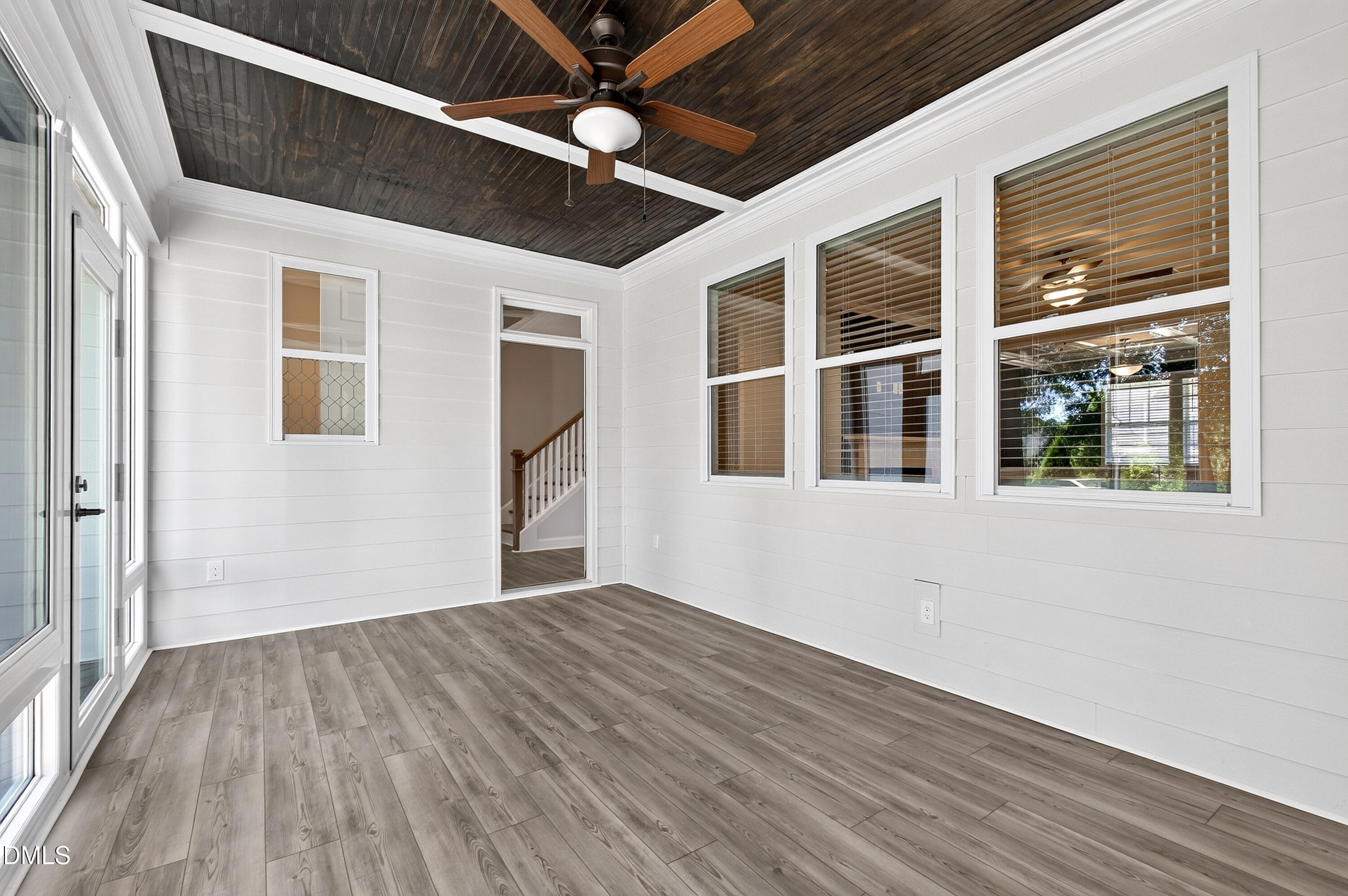 1300 Commons Ford Place Apex, NC 27539 - Photo 25 of 70 a view of an empty room with a window and wooden floor