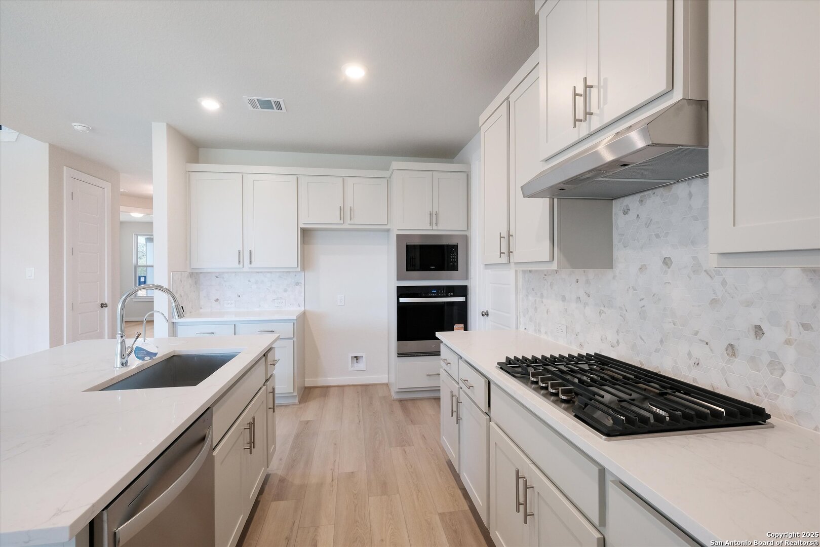 444 Foxbrook Way Cibolo, TX 78108 - Photo 11 of 32 a kitchen with a sink a stove and cabinets