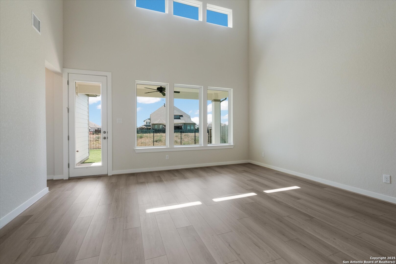 444 Foxbrook Way Cibolo, TX 78108 - Photo 3 of 17 wooden floor in an empty room with a window