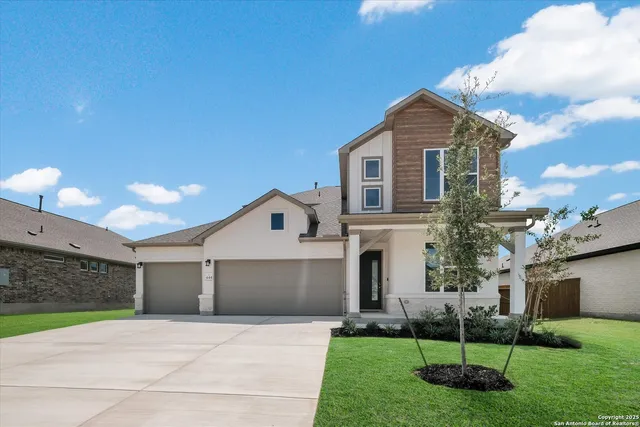 a front view of a house with a yard and a garage