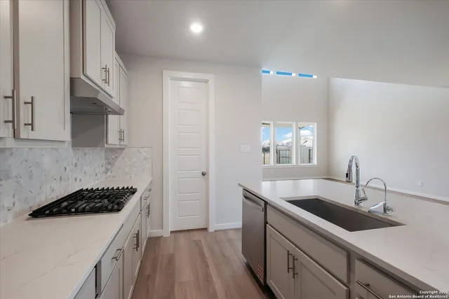 a kitchen that has a sink and a stove