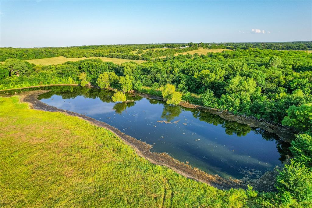 1922 A Bethel-Cannon Road Whitewright, TX 75491 - Photo 25 of 40 Expansive body of water surrounded by lush greenery and a natural landscape
