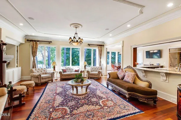 a bedroom with a bed a chandelier and a dresser