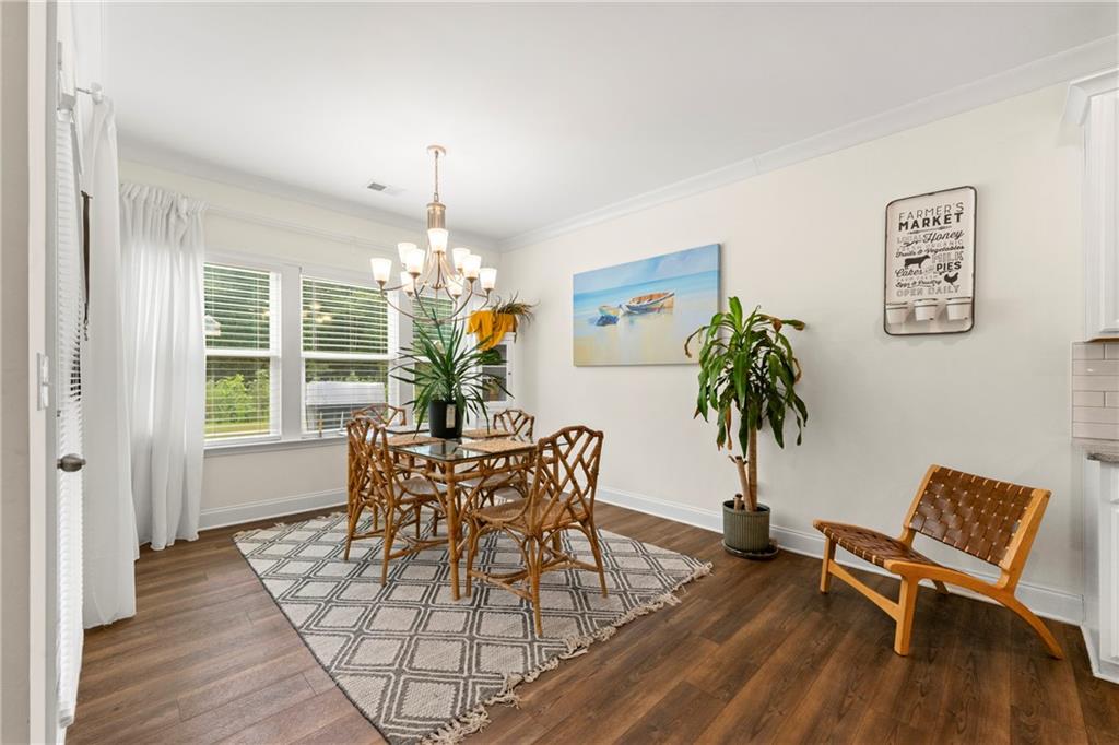 430 Plainfield Street Fayetteville, GA 30215 - Photo 12 of 21 a dining room with furniture potted plants and wooden floor