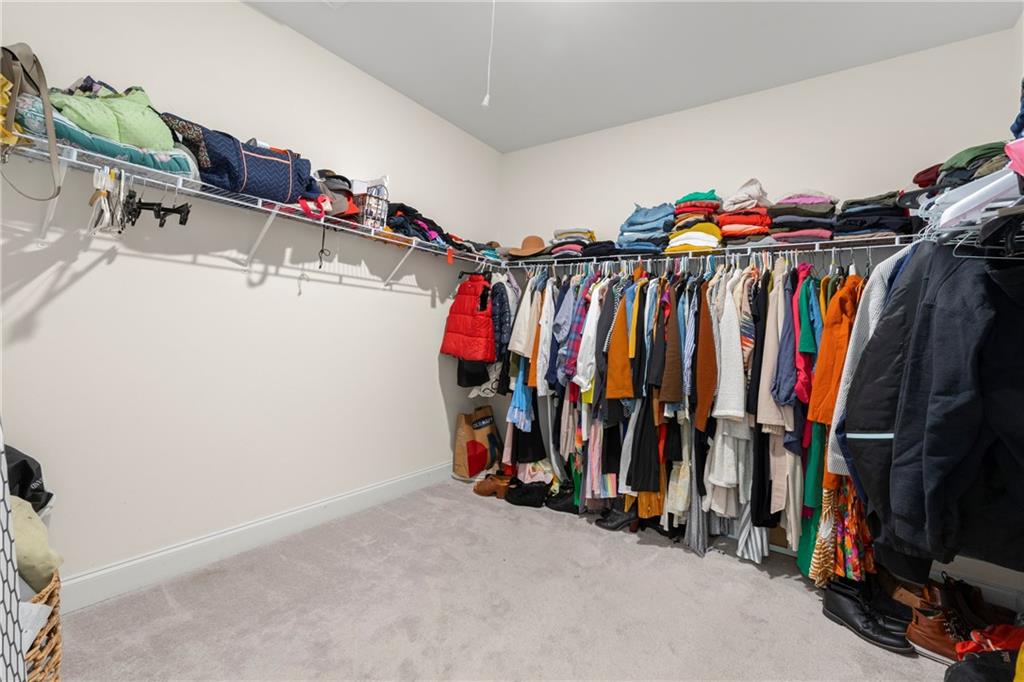 430 Plainfield Street Fayetteville, GA 30215 - Photo 15 of 21 a view of walk in closet with clothes