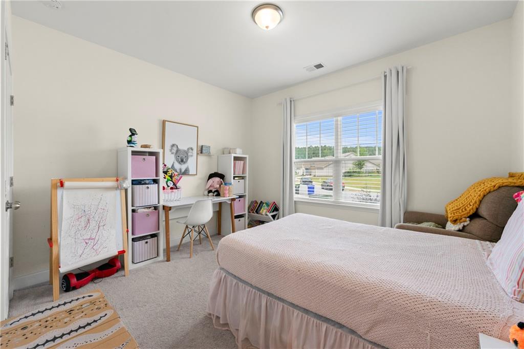 430 Plainfield Street Fayetteville, GA 30215 - Photo 16 of 21 a bedroom with a bed and a window