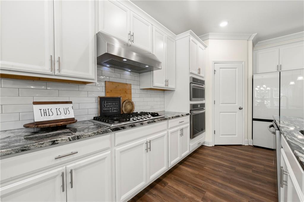 430 Plainfield Street Fayetteville, GA 30215 - Photo 9 of 21 a kitchen with stainless steel appliances granite countertop a stove and a refrigerator