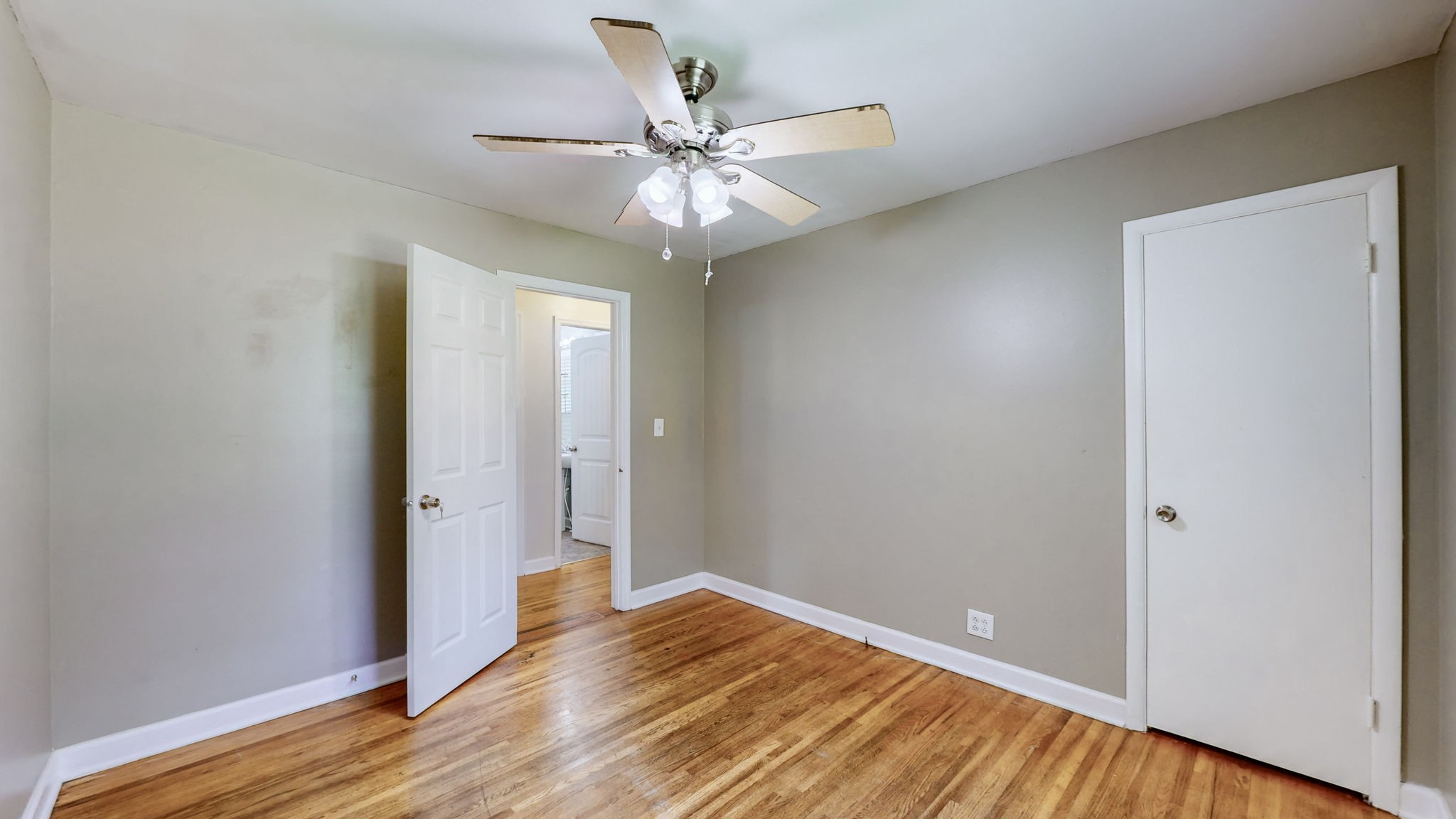 1007 Hunt Street Murfreesboro, TN 37130 - Photo 32 of 58 a view of an empty room with wooden floor and a ceiling fan