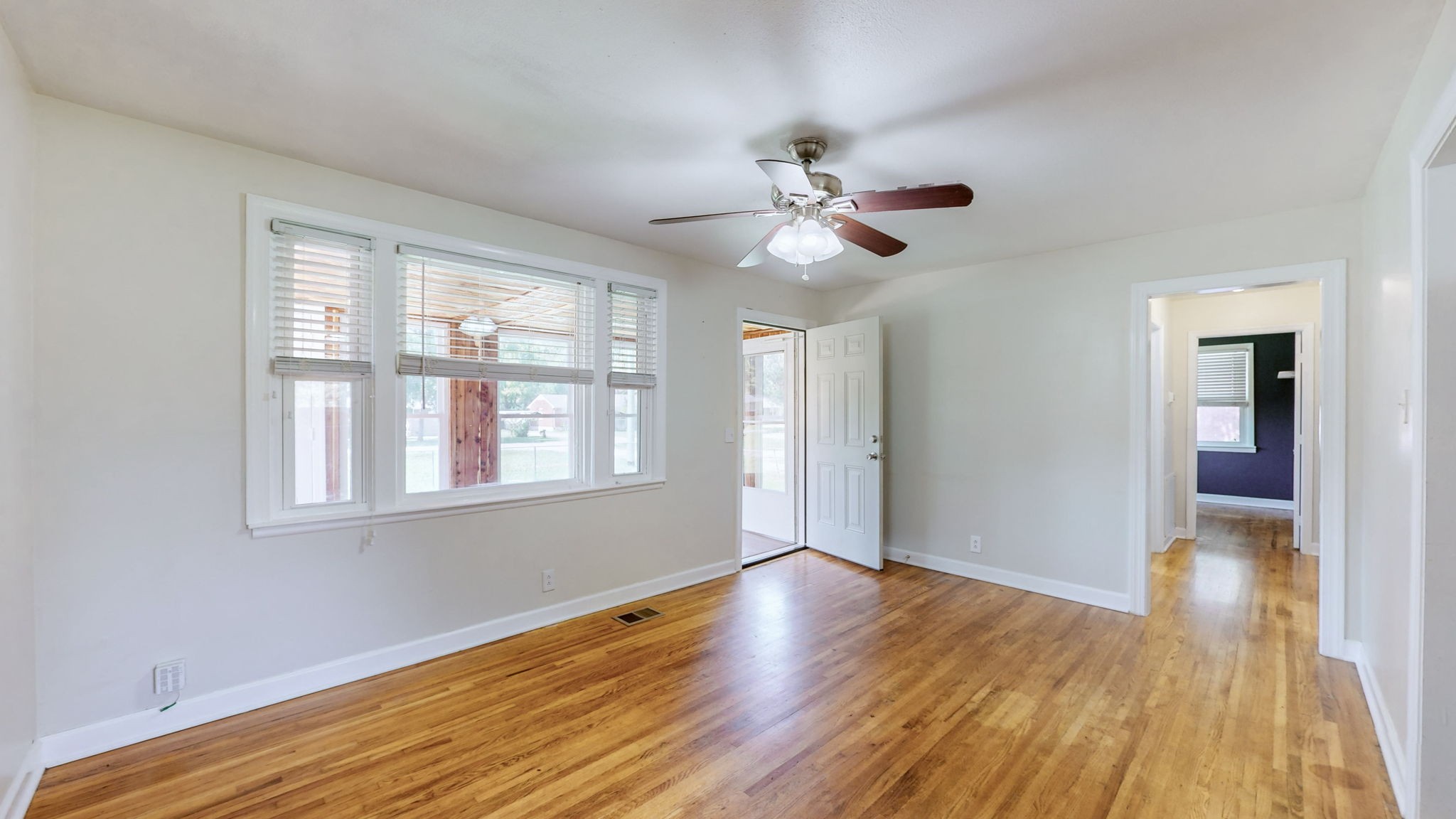 1007 Hunt Street Murfreesboro, TN 37130 - Photo 8 of 58 a view of an empty room with wooden floor and a window
