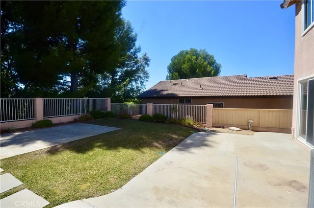 a view of backyard with wooden fence