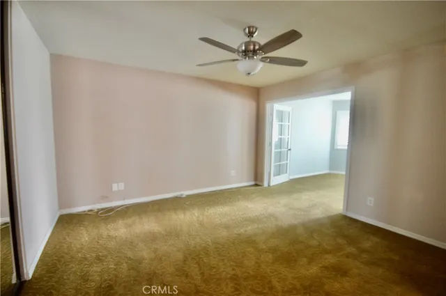 a view of a big room with a chandelier fan