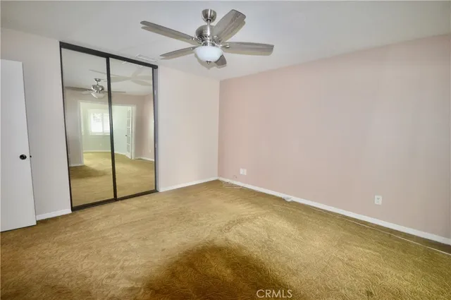 a view of an empty room with a fan