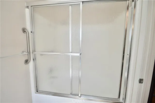 a bathroom with a glass shower door