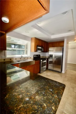 a kitchen with stainless steel appliances granite countertop a sink stove and granite counter top
