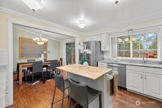 5527 153rd Street Southwest Edmonds, WA 98026 - Photo 13 of 40 a kitchen with a dining table chairs and large window