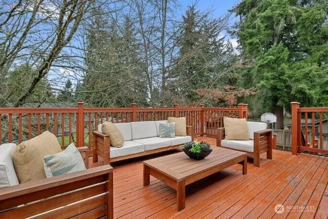 a outdoor living room with furniture and wooden floor