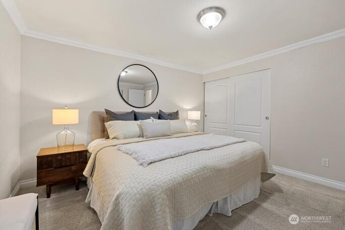 5527 153rd Street Southwest Edmonds, WA 98026 - Photo 20 of 40 a bedroom with a bed and a lamp