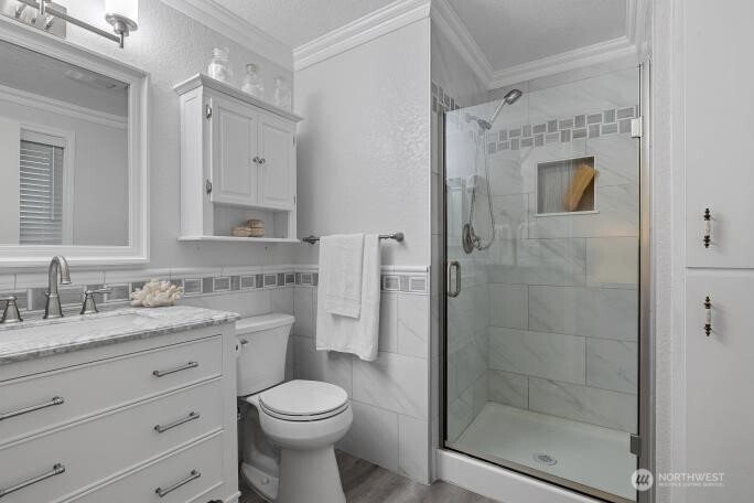 5527 153rd Street Southwest Edmonds, WA 98026 - Photo 22 of 40 a bathroom with a shower sink vanity and toilet