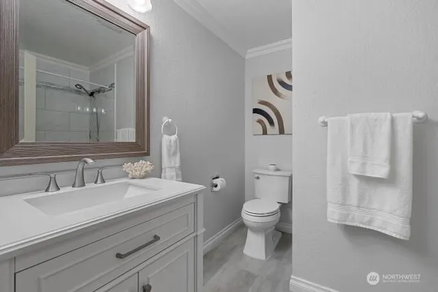 a bathroom with a toilet sink and mirror