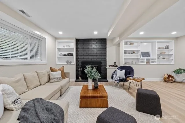 a living room with furniture and a fireplace
