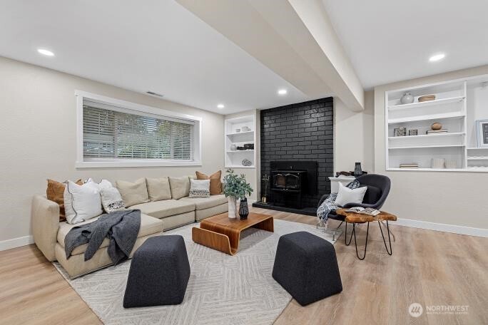 5527 153rd Street Southwest Edmonds, WA 98026 - Photo 28 of 40 a living room with furniture and a fireplace