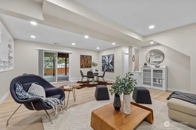 a living room with furniture potted plant and window