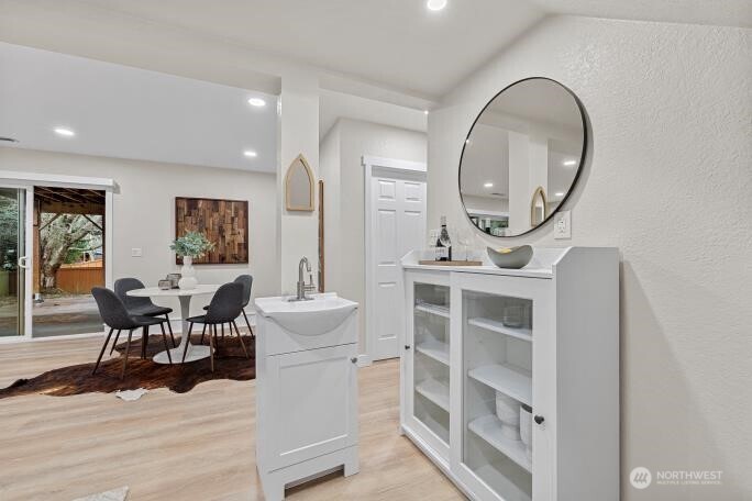 5527 153rd Street Southwest Edmonds, WA 98026 - Photo 31 of 40 a living room with furniture a mirror a clock and a view of kitchen