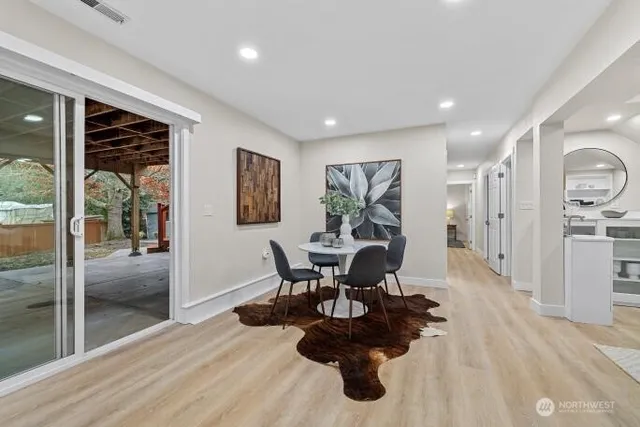 a dining room with furniture and wooden floor