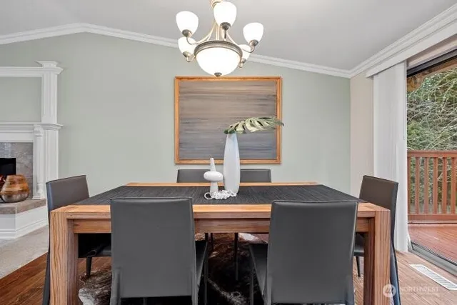 a view of a dining room with furniture and chandelier